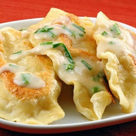 Pierogi homemade with sour cream sauce