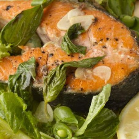 Salmon Pan Roast with Garlic Shavings and Basil on Fresh Greens