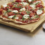 Cracker-Thin Pizza with Cherry Tomatoes, Fresh Mozzarella, Ricotta, and Basil