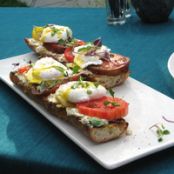 Poached Eggs on Toasted Baguette with Goat Cheese, and Black Pepper Vinaigrette