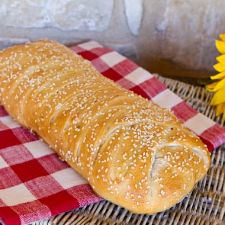 Stromboli with Olives, Sun-Dried Tomatoes, Ham, Salami, and Cheese