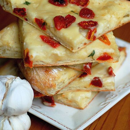 white pizza with roasted garlic coconut cream and sun dried tomatoes