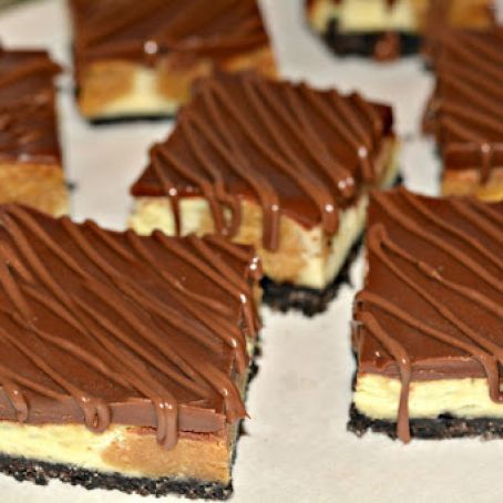 PEANUT BUTTER COOKIE DOUGH CHEESECAKE BARS ON AN OREO CRUST AND TOPPED WITH A MILK CHOCOLATE GLAZE!