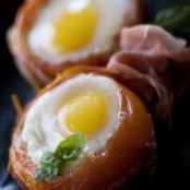Eggs baked in tomatoes with prosciutto and basil puree