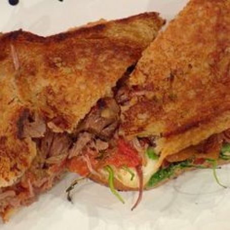 Griddled Braised Beef Sandwich with Caramelized Onions, Tomato Jam, Arugula and Taleggio