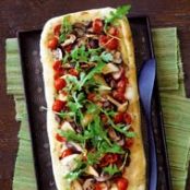 Mushroom and Tomato Flatbread Topped with Fresh Arugula