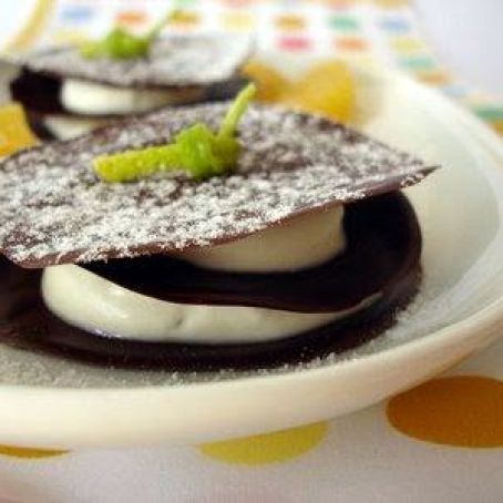 Chocolate discs with orange cream and marinated oranges