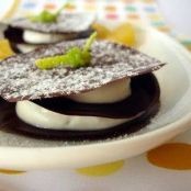 Chocolate discs with orange cream and marinated oranges