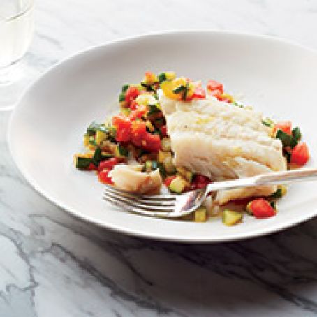 Olive Oil-Poached Hake on SautÃ©ed Zucchini with Tomatoes © Con Poulos Olive Oil-Poached Hake on Sautéed Zucchini with Tomatoes