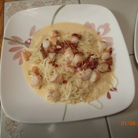Shrimp and fettuccine with sun-dried tomatoes in a cream sauce