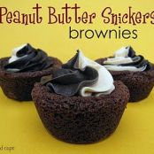 Peanut Butter Snickers Brownies topped with Chocolate and Peanut Butter Swirled Frosting